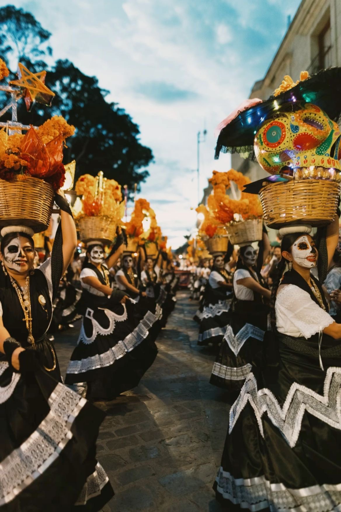 A Día de Muertos procession with dancers in traditional dress