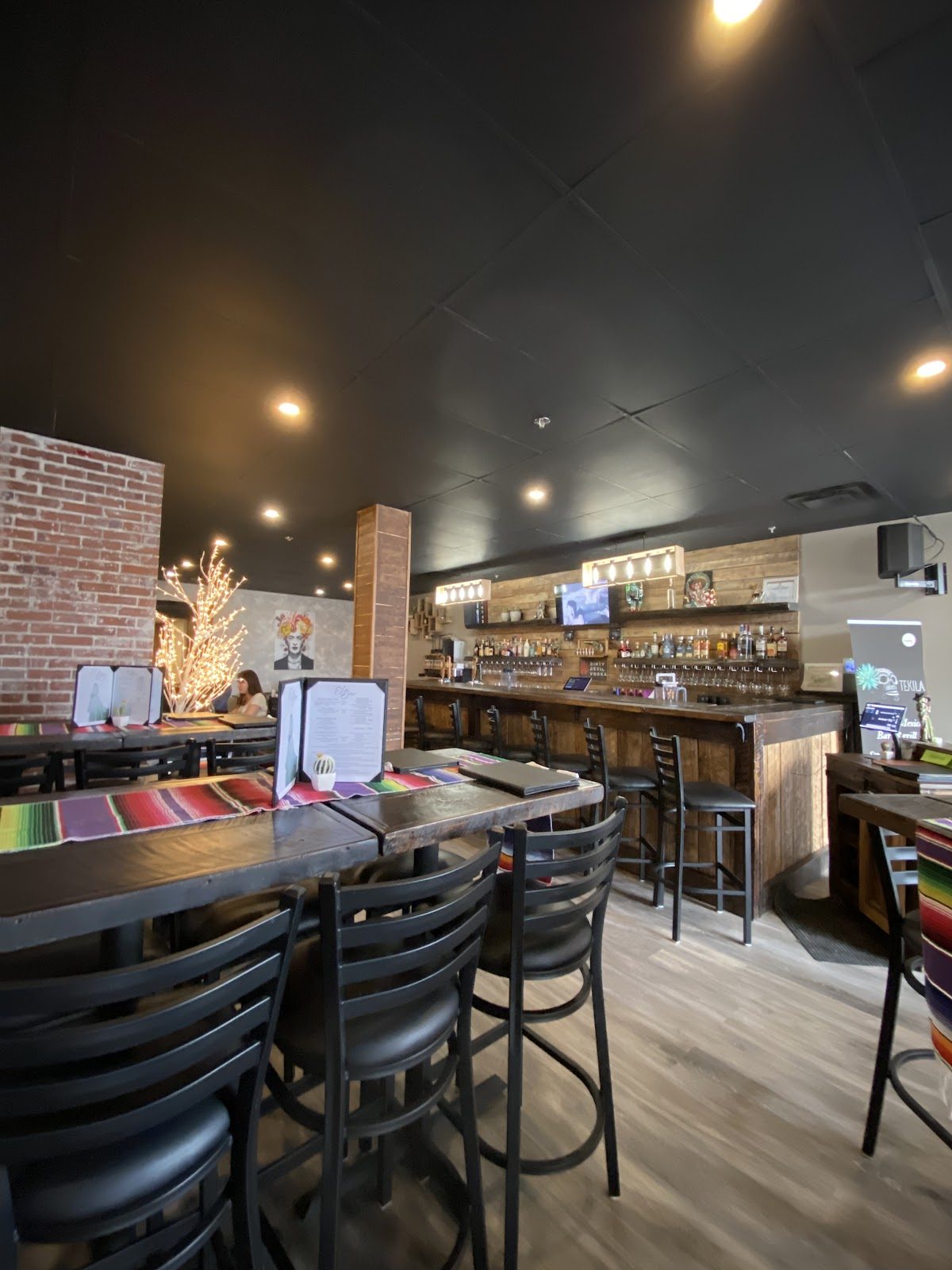 The dining room and bar at Tekila, brick wall and warm lamps